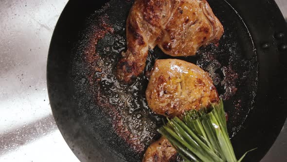 Oil Dabbing Chicken Thighs With Lemongrass While Cooking In A Pan. top-down