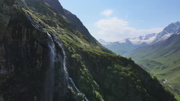 Water Flows Down the Slope of a Mountain Drops Splash From a Huge Rock