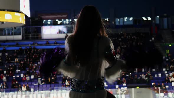 Silhouette of Slim Cheerleader Woman Dancing at Hockey Game