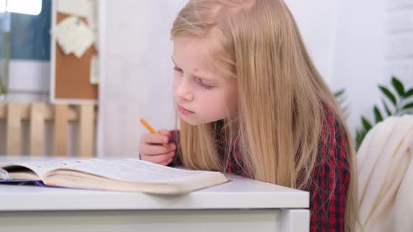 Blonde Schoolgirl Studying at Home Doing School Homework