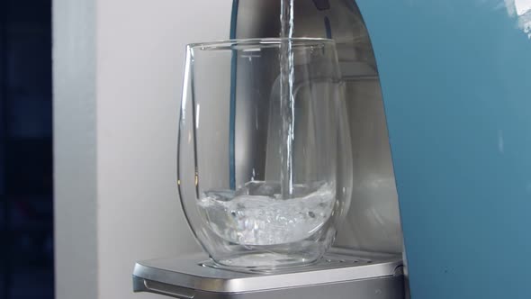 Slow motion of a water cup filling in a water filtering machine