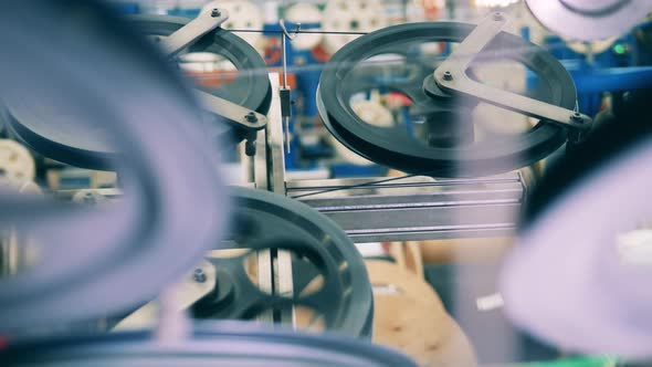 Several Spinning Shafts with Wires at a Factory