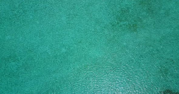 Natural aerial clean view of a white sand paradise beach and aqua turquoise water background in vibr