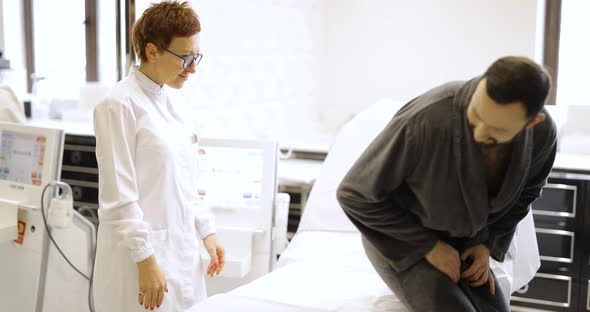 Cosmetologist in White Robe with Patient in Cosmetology Salon