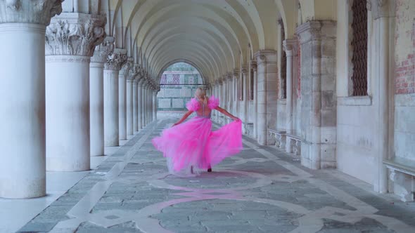 Fashion Model in the Pink Dress Walks Under Arches Tunnel in Venice