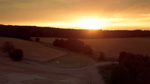 yellow sunset in summer countryside landscape