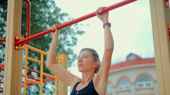 Pull Ups Exercising Workout.Woman Pull Ups Outdoor.Wellness Muscular And Athletic.Aerobics Sport
