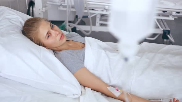 Young Female Patient Lying in a Hospital Room