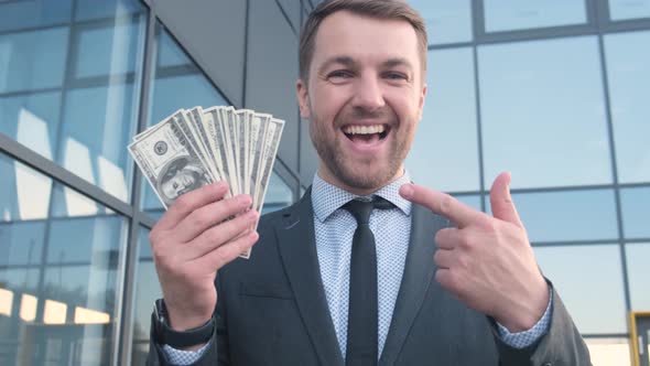 Portrait of a Business Man Holding Money