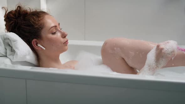 Caucasian woman taking a bath and shaving legs. Shot with RED helium camera in 4K.