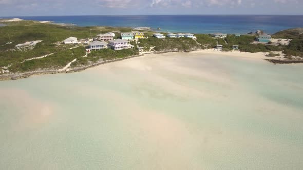 Aerial drone view clear water, houses on tropical island beach and coast in the Bahamas, Caribbean. 