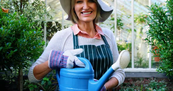 Mature woman holding watering can