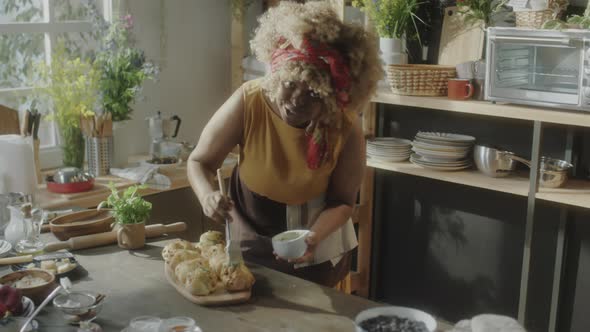 Female Food Blogger Glazing Freshly Baked Pastries