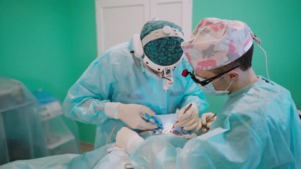 Surgeon at work in operating room. Team of professional surgeons performing operation in clinic