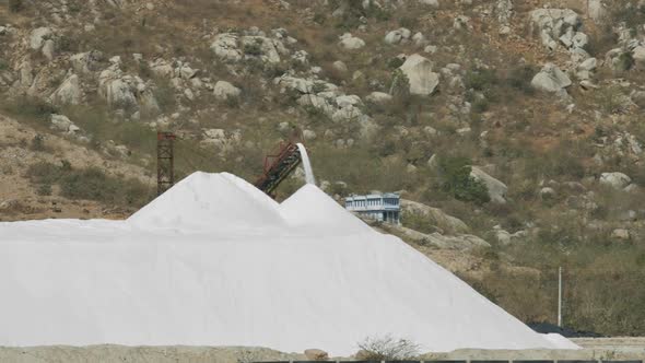 Distant View Conveyor Pours Extracted Salt To Heap