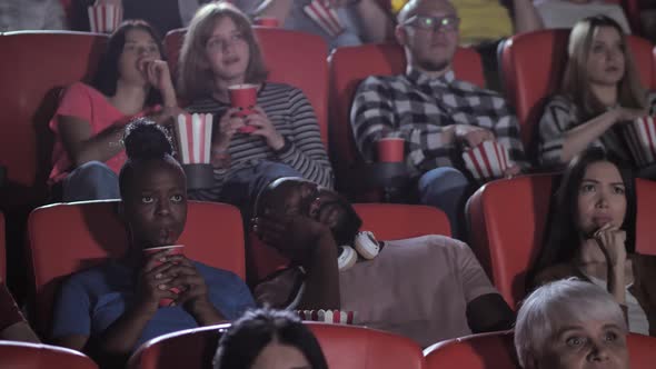 Dark-skinned Male Spectator Sleeping During Movie