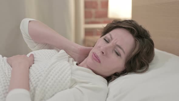 Sleeping Old Woman Having Neck Pain in Bed 