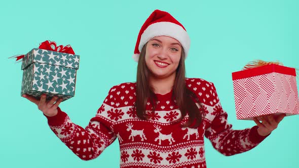 Woman in Christmas Red Sweater Santa Hat Smiling Holding Two Gift Boxes New Year Presents Shopping