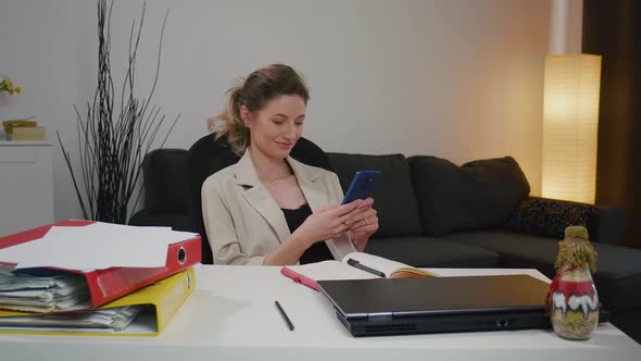 Woman using smartphone after a successful day's work.