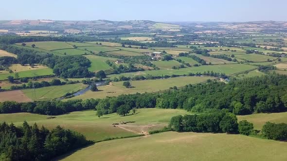 Drone footage of a vast beautiful countryside valley.