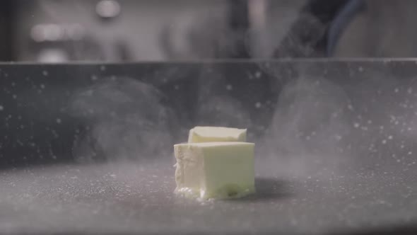 Falling of the Two Pieces of Butter Cube From Wood on Frying Pan