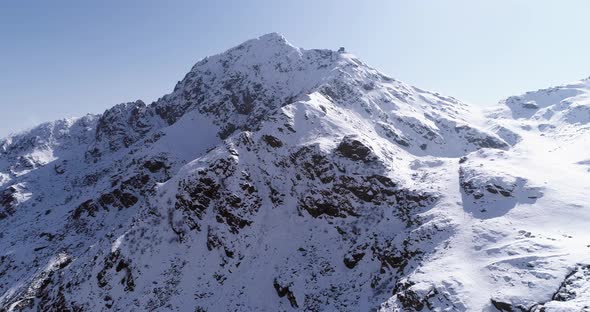 Aerial Flying Moving Forward Over Snowy Mountain Peak Ridge Establisher