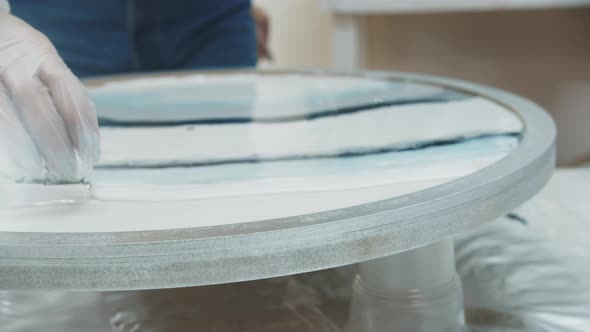 Pouring White Epoxy Paint on the Surface of the Art Object