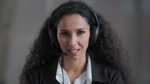 Front View of Young Hispanic Lady Stress Resistant Bank Worker Operator Looking at Camera in