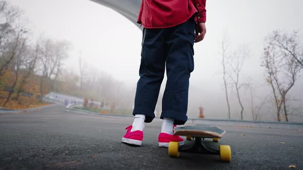 Rear View Legs of an Unrecognizable Teenager on a Skateboard