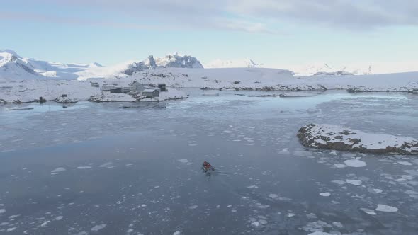 People in Rubber Inflatable Motor Boat Sail in Antarctic Ice To Polar Station