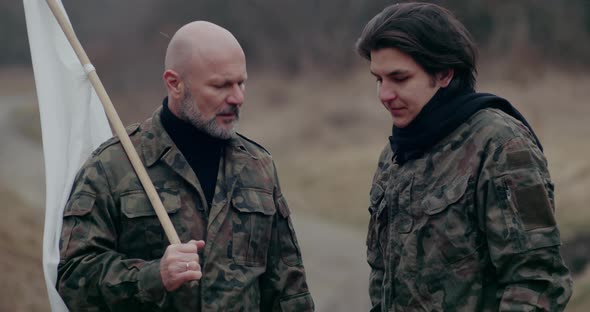 Army Man Holding White Flag Discussing With Soldier