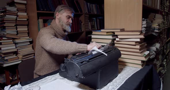 Ernest Hemingway is ripping out a sheet of paper out of the typewriter, 4k