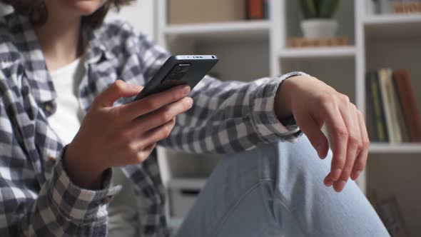 The Girl Holds The Phone In Her Hands Typing Text Answering Messages In Messengers