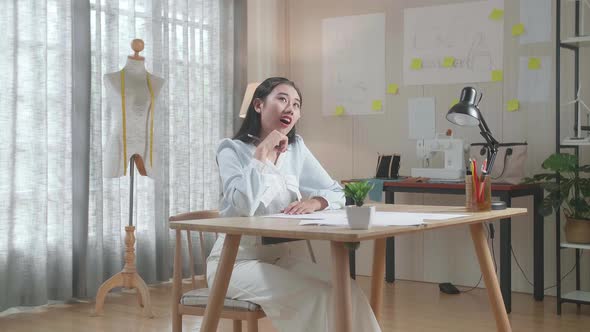 Asian Woman Designer Thinking While Drawing On The Layout Bond At The Office