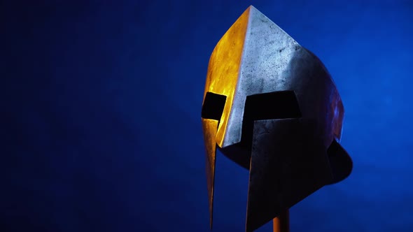 Old Spartan Helmet Isolated on Blue.