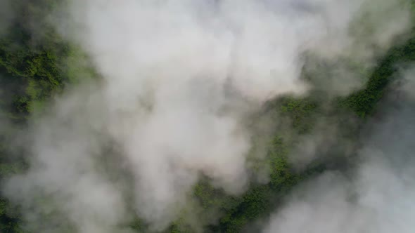 Aerial top view from drone above the mountain fog in the morning