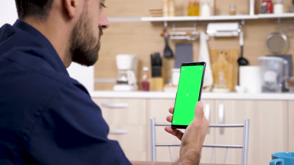 Man Holding a Phone in His Hands