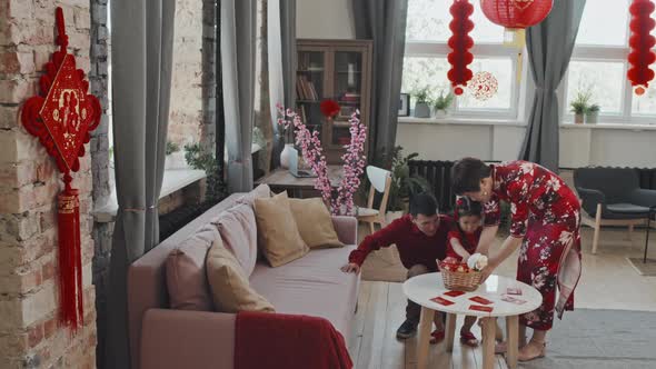 Chinese Family Arranging Gift Basket for Lunar New Year