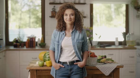 Portrait of smiling woman in her kitchen