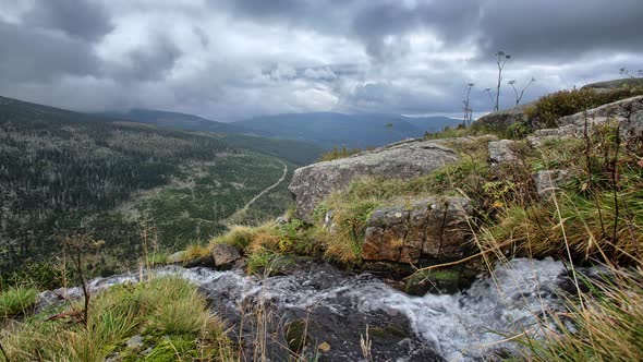 Stream flowing from the rock overlooking the landscape. Time lapse , Czech republic