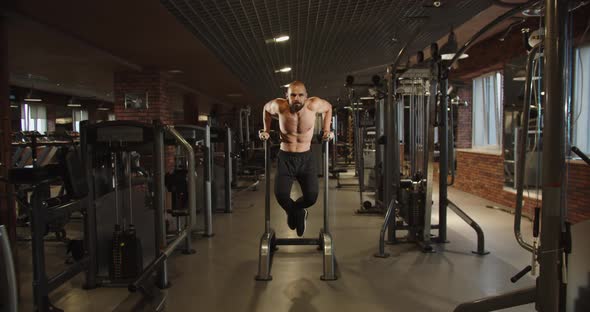 Handsome Sportsman Bodybuilder Doing Pullup Exercises in the Gym