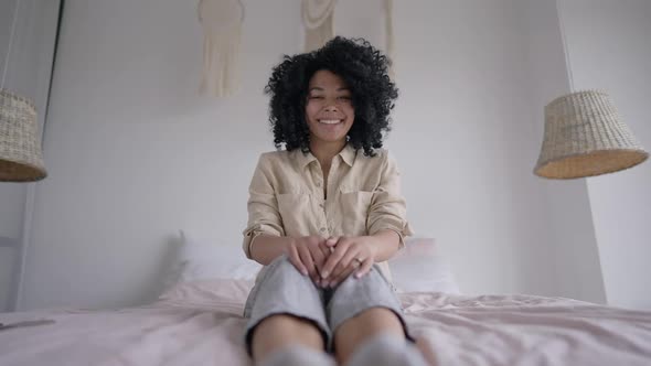 Web Conference POV of Cheerful Young Woman Laughing Sitting on Cozy Bed in Home Office