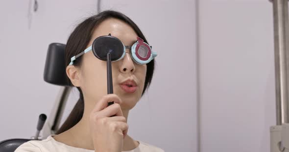 Asian Woman diagnosis eye test in clinic