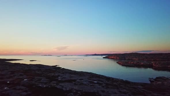 Drone flying over Swedish water during sundown