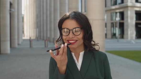 Businesswoman Talking on Phone and Walking