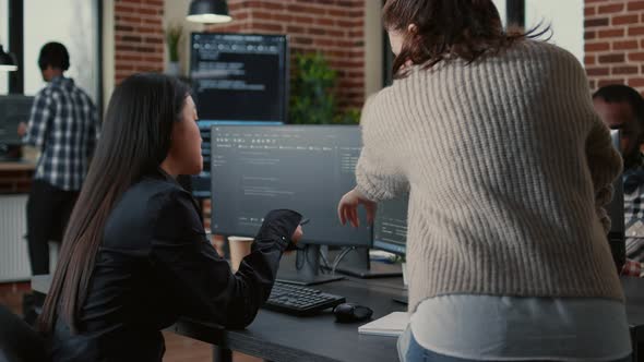 Programer Pointing Pencil at Computer Screen with Software Compiling Code Explaining Source