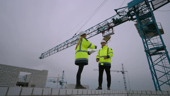 Building Inspector is Giving Documentation to Civil Engineer in Construction Site