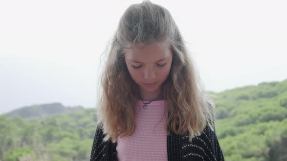 Portrait of blond girl looking at camera