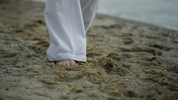 Unknown Barefoot Man Stepping on Beach Closeup