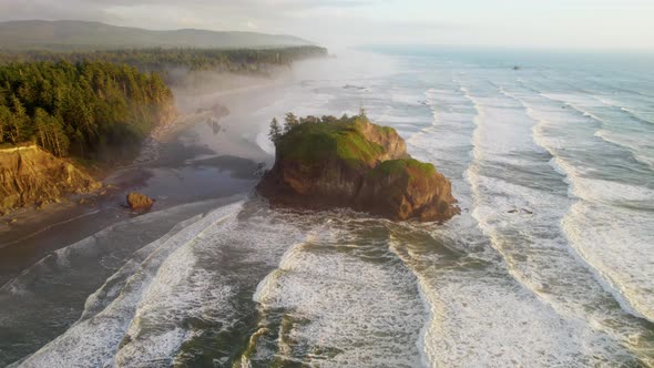 Pacific Waves and Huge Stones on the Shore in Sunset Light Fog on the Beach